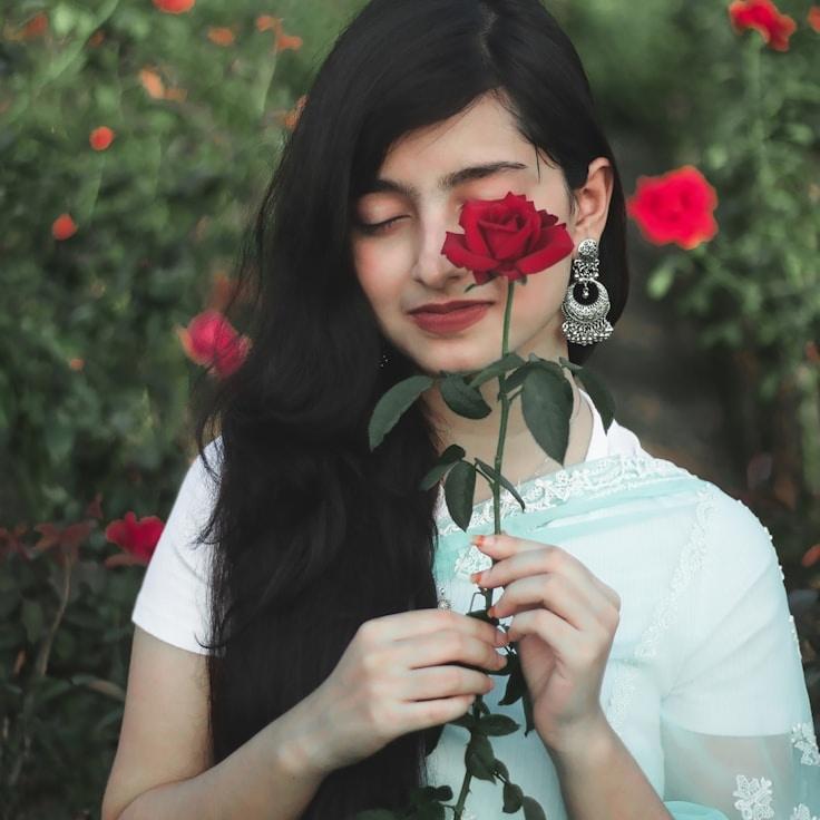 Kaveri Mehta, Lead Design Curator at Flame Haven Tide, reviewing corporate floral arrangements